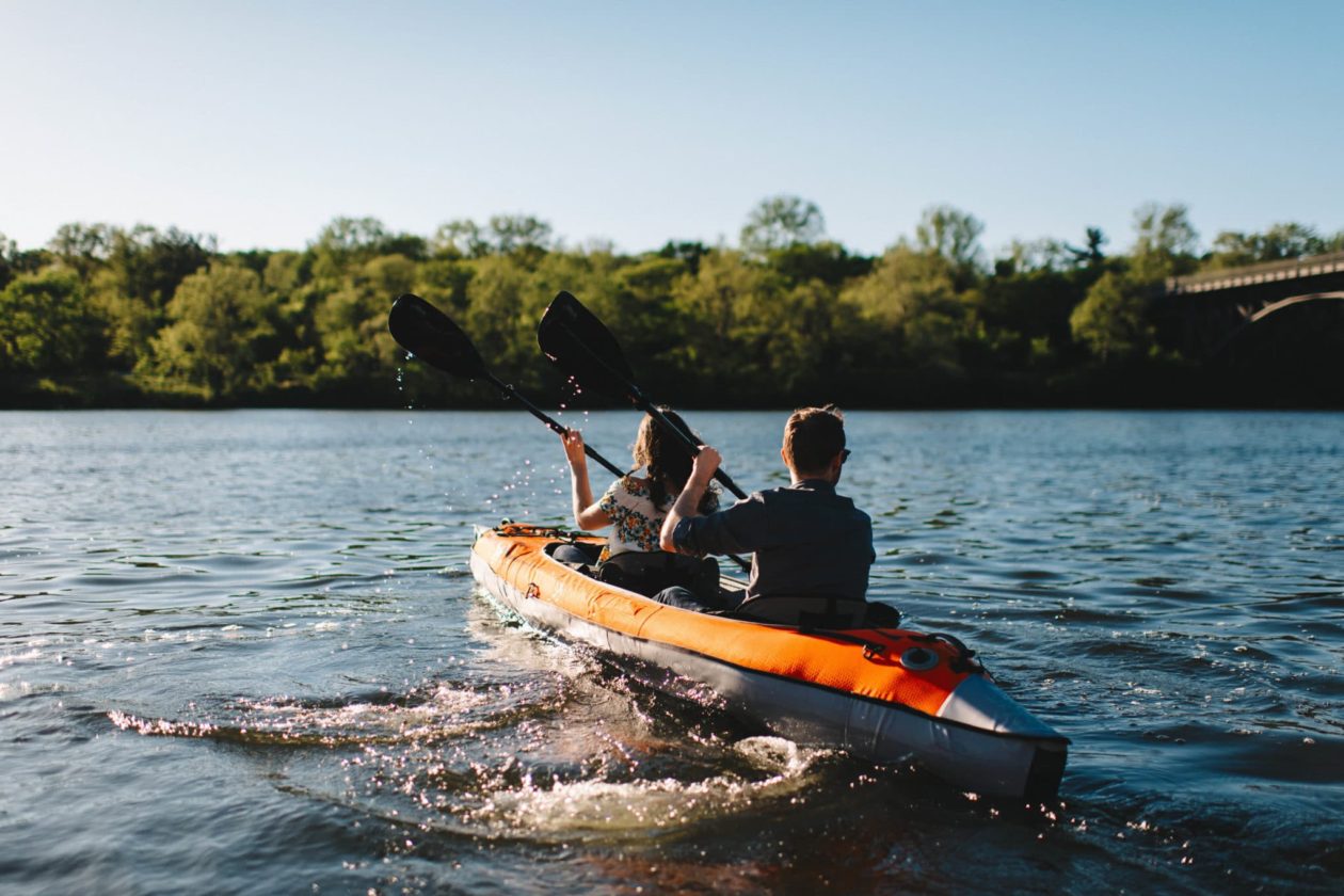 Couple in orange kayak paddling away